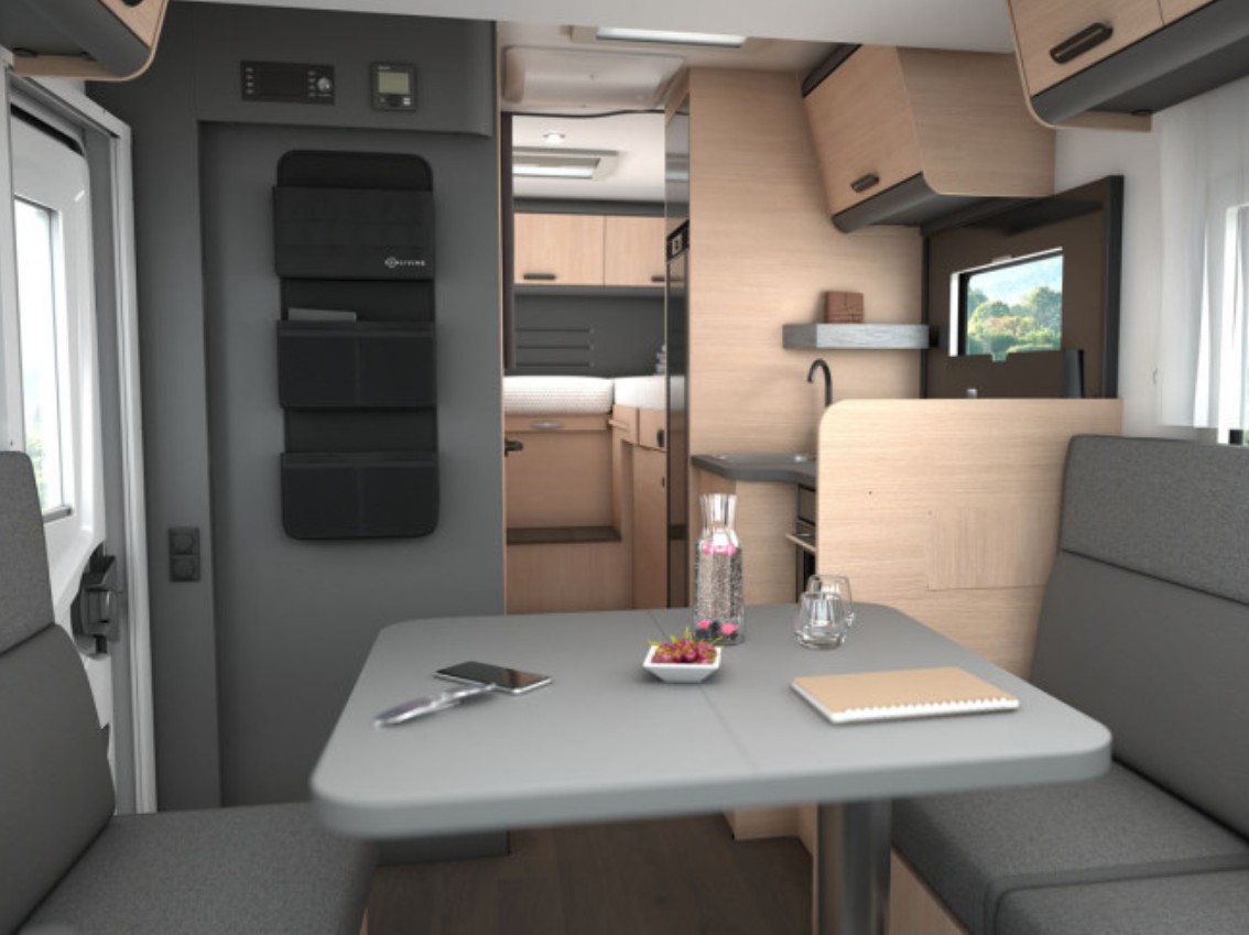 Overzicht van het interieur van de Sun Living S72DL camper, met zicht op de zithoek, keuken, bovenbed en het strakke, moderne design van de leefruimte